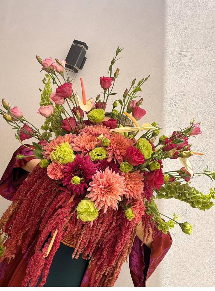 Arreglo floral en tonos coral, vino y verde